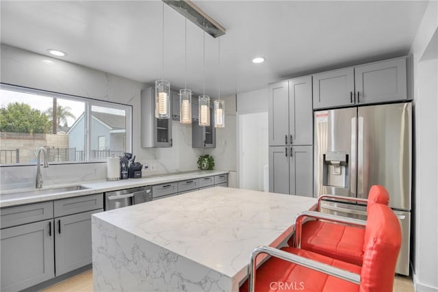 1158 N Ivescrest Ave, Covina, CA 91724 - kitchen with gray cabinetry, light stone counters, pendant lighting, appliances with stainless steel finishes, and recessed lighting
