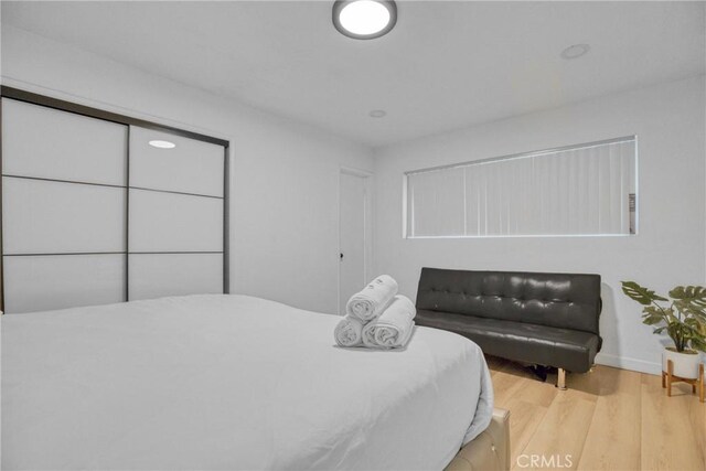1158 N Ivescrest Ave, Covina, CA 91724 - bedroom featuring wood finished floors and baseboards