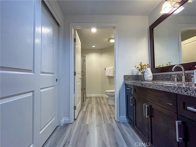 600 N Atlantic Blvd Unit 625, Monterey Park, CA 91754 - bathroom featuring wood finished floors, vanity, toilet, baseboards, and recessed lighting
