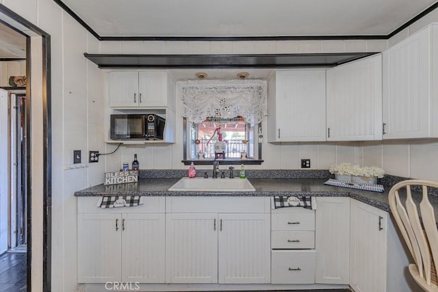 12845 7th, Chino, CA 91710 - kitchen with a sink, black microwave, dark countertops, and white cabinetry