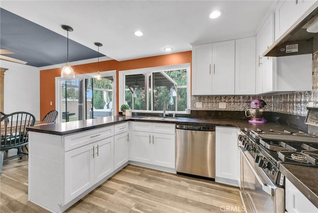 737 Cobb Ave, Placentia, CA 92870 - kitchen featuring stainless steel appliances, under cabinet range hood, dark countertops, a peninsula, and recessed lighting