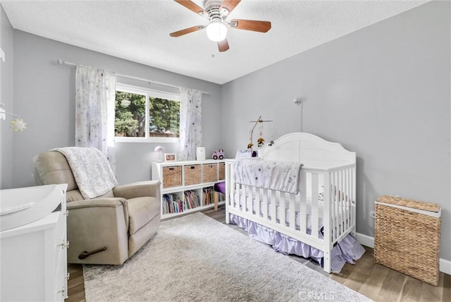 737 Cobb Ave, Placentia, CA 92870 - bedroom featuring wood finished floors, a nursery area, ceiling fan, and a textured ceiling