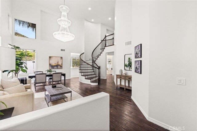 16209 Eagleridge Ct, La Mirada, CA 90638 - living area featuring healthy amount of natural light, stairway, hardwood / wood-style floors, baseboards, and a towering ceiling