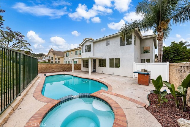 16209 Eagleridge Ct, La Mirada, CA 90638 - view of swimming pool featuring a pool with connected hot tub, a fenced backyard, and a patio