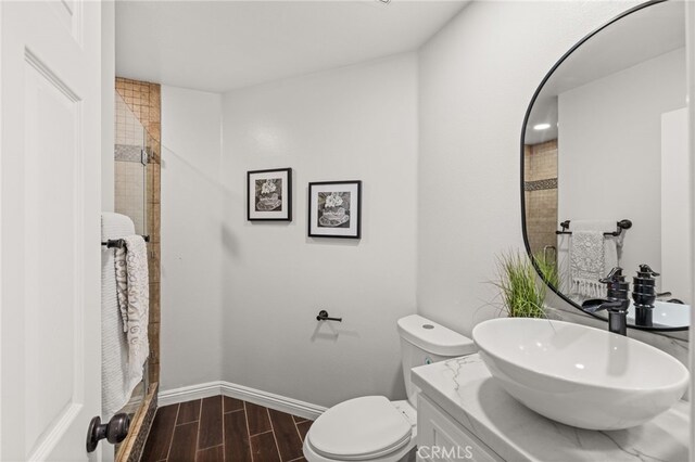 16209 Eagleridge Ct, La Mirada, CA 90638 - full bath with toilet, vanity, wood tiled floors, baseboards, and tiled shower