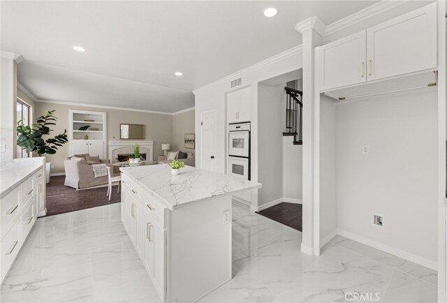16209 Eagleridge Ct, La Mirada, CA 90638 - kitchen with light marble finish flooring, double oven, a kitchen island, light stone countertops, and recessed lighting