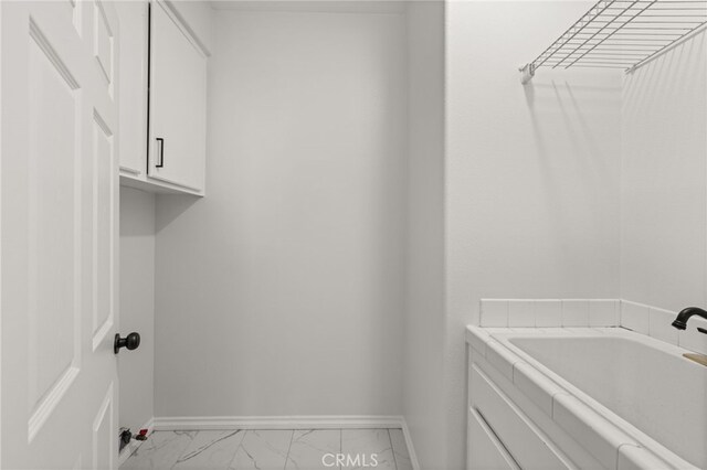 16209 Eagleridge Ct, La Mirada, CA 90638 - laundry room with baseboards, light marble finish floors, and a sink