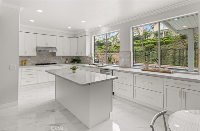 16209 Eagleridge Ct, La Mirada, CA 90638 - kitchen with under cabinet range hood, healthy amount of natural light, gas cooktop, light stone countertops, and crown molding