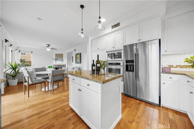 26 Middleton, Irvine, CA 92620 - kitchen with appliances with stainless steel finishes, ornamental molding, backsplash, ceiling fan, and white cabinetry
