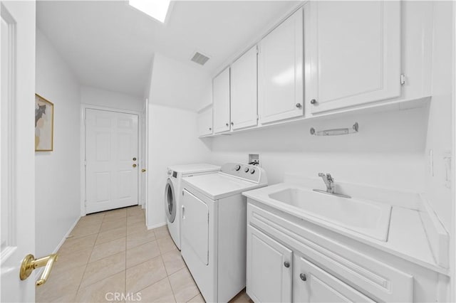 26 Middleton, Irvine, CA 92620 - washroom featuring washing machine and dryer, cabinet space, light tile patterned floors, and baseboards