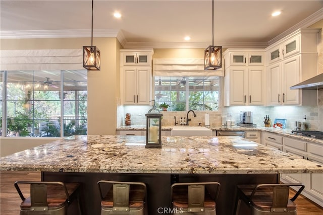 42926 Joshua Tree Ct, Murrieta, CA 92562 - kitchen with a sink, a kitchen breakfast bar, crown molding, backsplash, and a center island