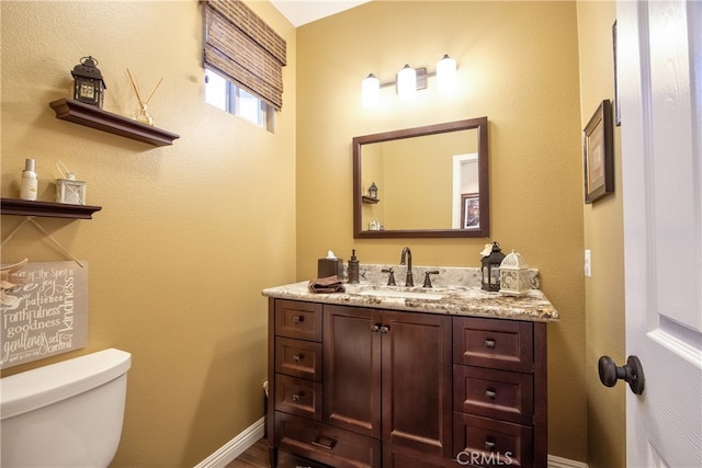 42926 Joshua Tree Ct, Murrieta, CA 92562 - half bathroom featuring toilet, vanity, and baseboards