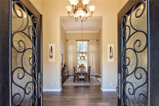 42926 Joshua Tree Ct, Murrieta, CA 92562 - foyer with a chandelier, dark wood-style flooring, baseboards, crown molding, and a towering ceiling