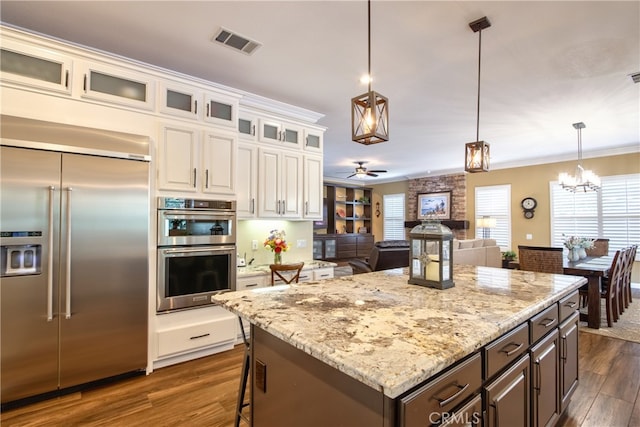 42926 Joshua Tree Ct, Murrieta, CA 92562 - kitchen with appliances with stainless steel finishes, ceiling fan, dark wood finished floors, white cabinetry, and ornamental molding