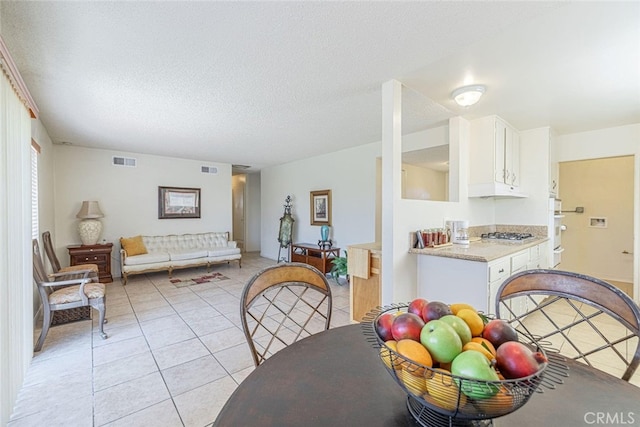 45409 Rodin Ave, Lancaster, CA 93535 - dining area featuring light tile patterned floors and a textured ceiling