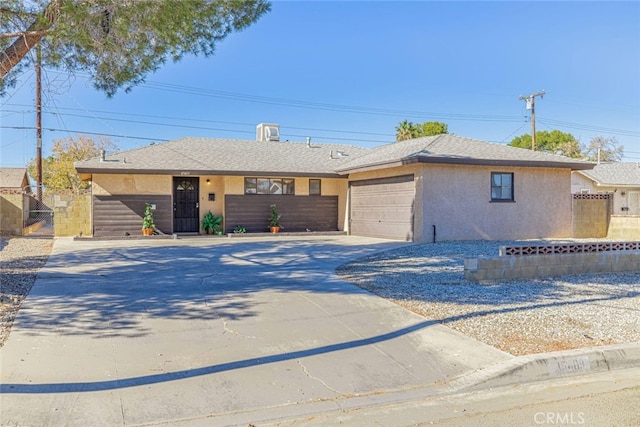 45409 Rodin Ave, Lancaster, CA 93535 - ranch-style house with stucco siding, driveway, a garage, and a gate