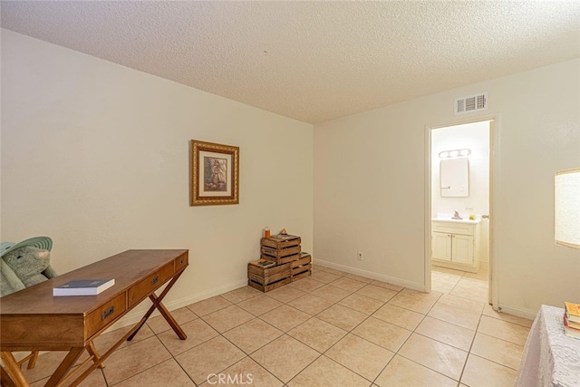 45409 Rodin Ave, Lancaster, CA 93535 - office space featuring light tile patterned floors, a textured ceiling, a sink, and baseboards