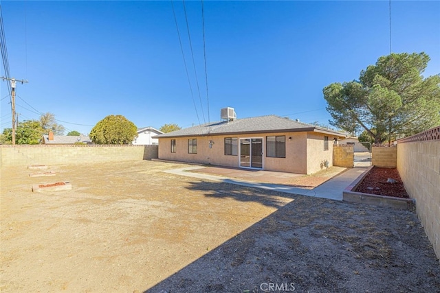 45409 Rodin Ave, Lancaster, CA 93535 - rear view of house with a fenced backyard, central AC unit, and stucco siding