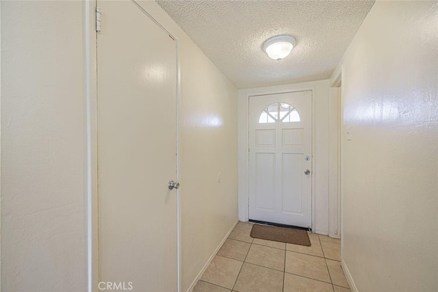 45409 Rodin Ave, Lancaster, CA 93535 - entryway with a textured ceiling, light tile patterned flooring, and baseboards