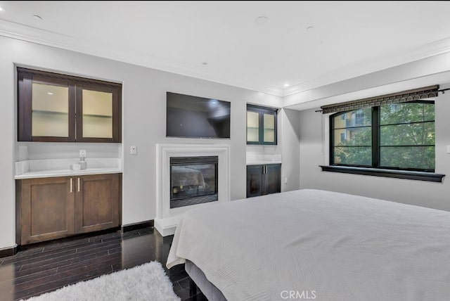 155 Cordova St Unit 203, Pasadena, CA 91105 - bedroom featuring ornamental molding, a glass covered fireplace, wood tiled floors, and recessed lighting