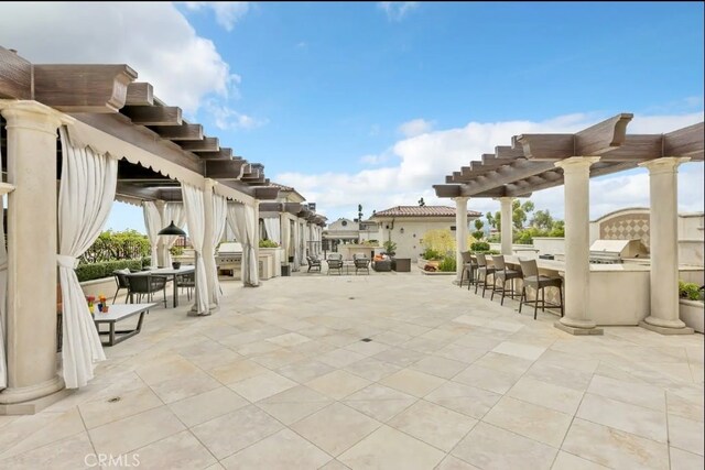 155 Cordova St Unit 203, Pasadena, CA 91105 - view of patio / terrace featuring outdoor dining space, a pergola, and exterior kitchen