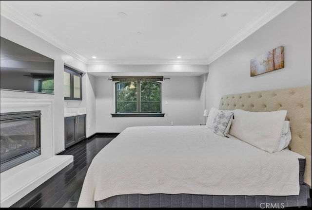 155 Cordova St Unit 203, Pasadena, CA 91105 - bedroom featuring dark wood finished floors, ornamental molding, a glass covered fireplace, and recessed lighting