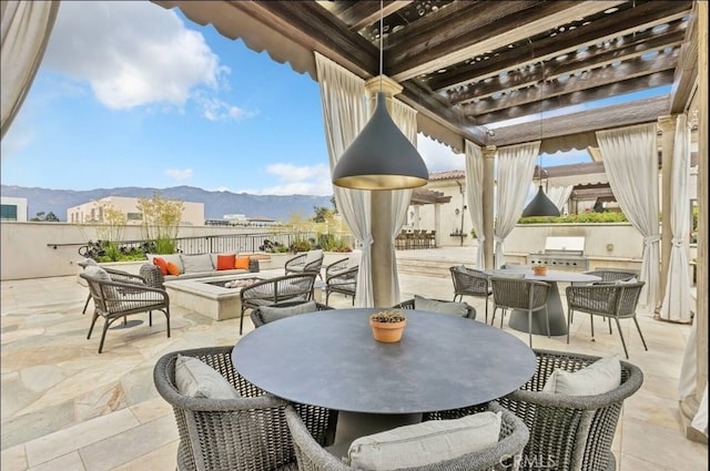 155 Cordova St Unit 203, Pasadena, CA 91105 - view of patio / terrace with a fire pit, outdoor dining area, an outdoor kitchen, a mountain view, and a pergola