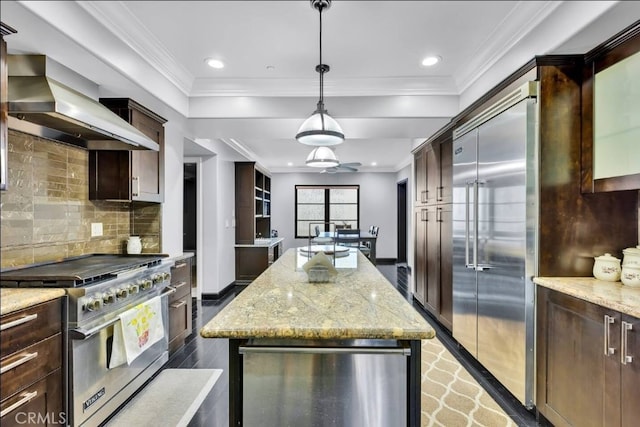 155 Cordova St Unit 203, Pasadena, CA 91105 - kitchen featuring wall chimney range hood, high end appliances, dark brown cabinetry, a center island, and ornamental molding