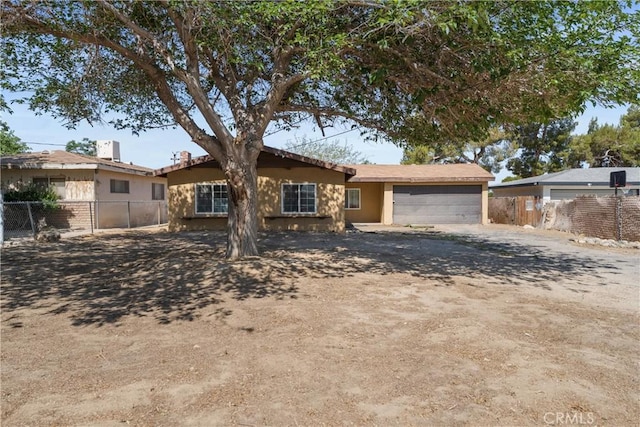 35921 80th St E, Littlerock, CA 93543 - view of front of house with a garage, dirt driveway, and stucco siding