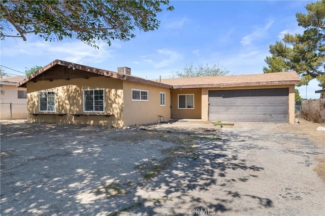35921 80th St E, Littlerock, CA 93543 - ranch-style home featuring a garage, driveway, and stucco siding