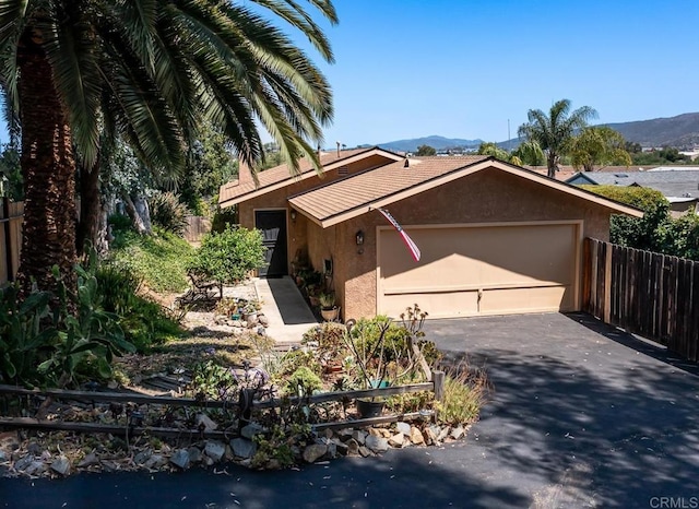 905 Discovery St, San Marcos, CA 92078 - view of front of home featuring stucco siding, a garage, asphalt driveway, and a mountain view