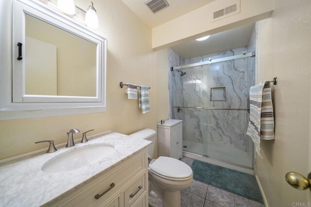 905 Discovery St, San Marcos, CA 92078 - bathroom with toilet, a marble finish shower, vanity, and tile patterned floors