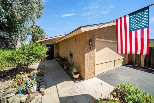 905 Discovery St, San Marcos, CA 92078 - view of home's exterior featuring stucco siding, an attached garage, and driveway