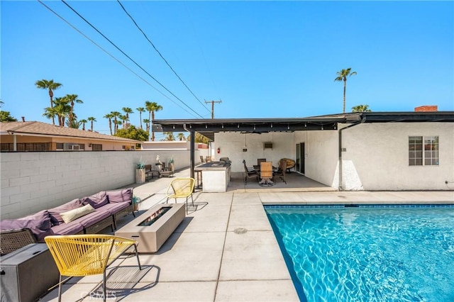 589 S Mountain View Dr, Palm Springs, CA 92264 - rear view of house featuring an outdoor living space with a fire pit, a patio, stucco siding, and a chimney