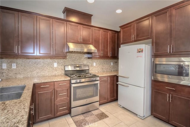 3212 Willow Creek Rd, West Covina, CA 91791 - kitchen with stainless steel appliances, under cabinet range hood, light tile patterned floors, tasteful backsplash, and recessed lighting