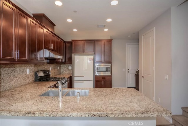 3212 Willow Creek Rd, West Covina, CA 91791 - kitchen with appliances with stainless steel finishes, a sink, under cabinet range hood, recessed lighting, and decorative backsplash