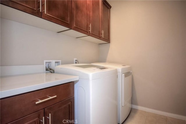 3212 Willow Creek Rd, West Covina, CA 91791 - laundry room featuring cabinet space, washer and dryer, baseboards, and light tile patterned floors