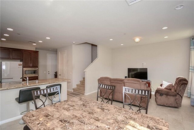 3212 Willow Creek Rd, West Covina, CA 91791 - dining room with recessed lighting, stairway, light tile patterned flooring, and baseboards