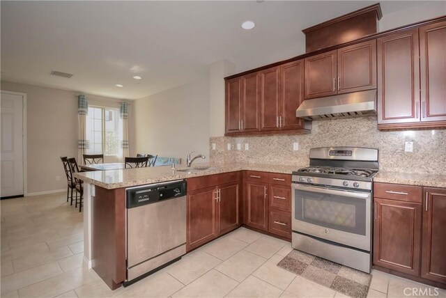 3212 Willow Creek Rd, West Covina, CA 91791 - kitchen with stainless steel appliances, under cabinet range hood, a sink, backsplash, and recessed lighting