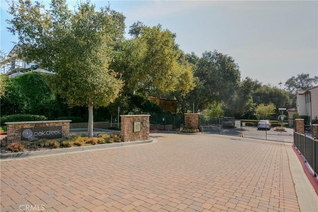 3212 Willow Creek Rd, West Covina, CA 91791 - view of decorative street with curbs, a gated entry, and a gate