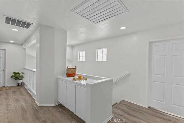 27051 Featherhill Dr, Corona, CA 92883 - corridor featuring wood finished floors, recessed lighting, a textured ceiling, an upstairs landing, and baseboards
