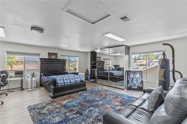 27051 Featherhill Dr, Corona, CA 92883 - bedroom with a textured ceiling, wood finished floors, multiple windows, and attic access