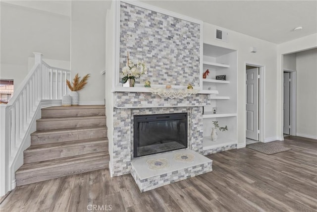 27051 Featherhill Dr, Corona, CA 92883 - living area featuring wood finished floors, stairway, built in features, and baseboards