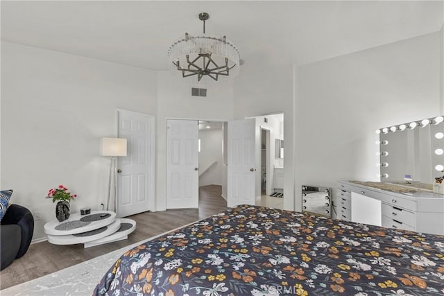 27051 Featherhill Dr, Corona, CA 92883 - bedroom featuring wood finished floors, a chandelier, and a towering ceiling