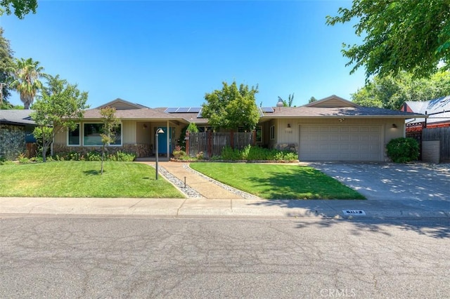 1160 Kentfield Rd, Chico, CA 95926 - ranch-style home featuring concrete driveway, solar panels, a garage, and stone siding