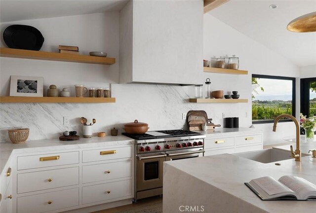 1936 Galaxy Dr, Newport Beach, CA 92660 - kitchen with range with two ovens, open shelves, a sink, vaulted ceiling, and backsplash