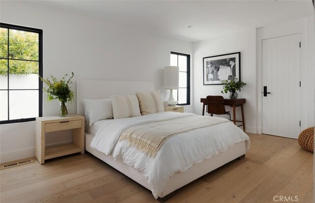 1936 Galaxy Dr, Newport Beach, CA 92660 - bedroom with multiple windows, light wood finished floors, and baseboards