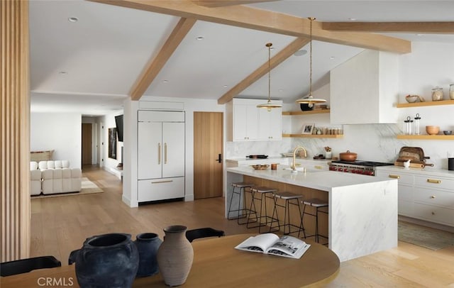 1936 Galaxy Dr, Newport Beach, CA 92660 - kitchen featuring paneled fridge, open shelves, a sink, a breakfast bar area, and light countertops