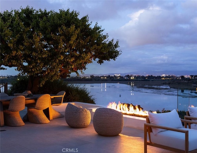 1936 Galaxy Dr, Newport Beach, CA 92660 - view of patio featuring a fire pit and a water view
