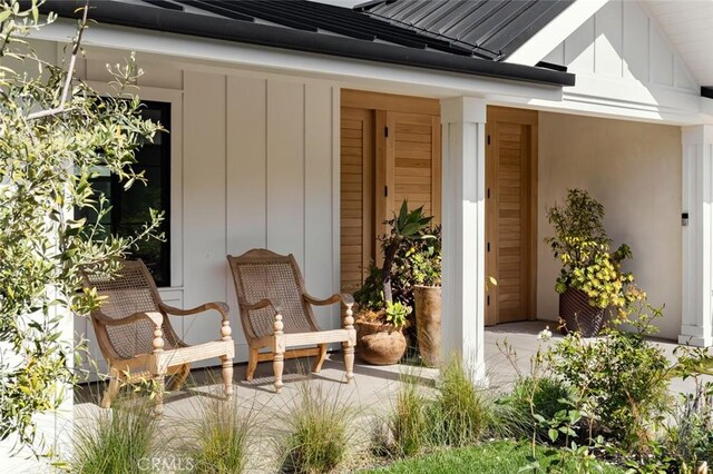 1936 Galaxy Dr, Newport Beach, CA 92660 - doorway to property featuring board and batten siding, metal roof, and a standing seam roof